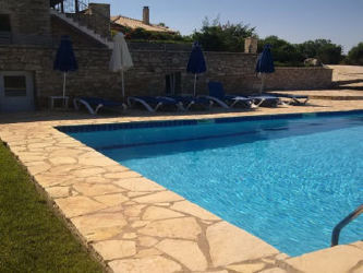 Poolside relaxation at rental Villa Karinyon Mystraki